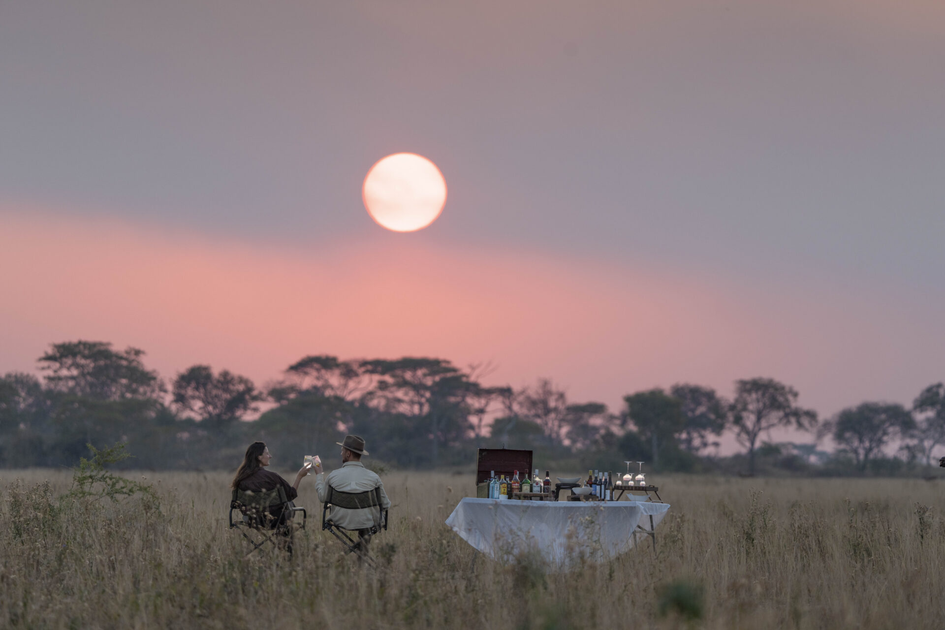 Sundowners at sunset on the Busanga Plains after an afternoon game drive with Chisa Busanga Camp